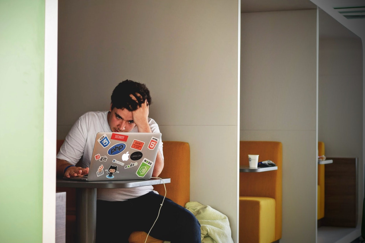 man-in-white-shirt-using-macbook-pro-52608